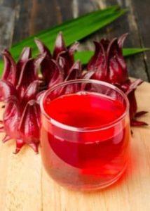 Jamaican sorrel drink with fres calyces sitting on a table